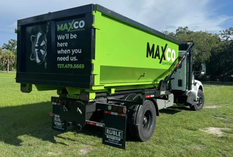 Rear of a MAXCO contractor dumpster on the roll-off truck